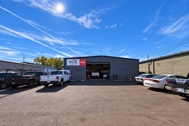 The Auto Motion shop building on SW Queen Ave in Albany on a sunny day, cars parked out front
